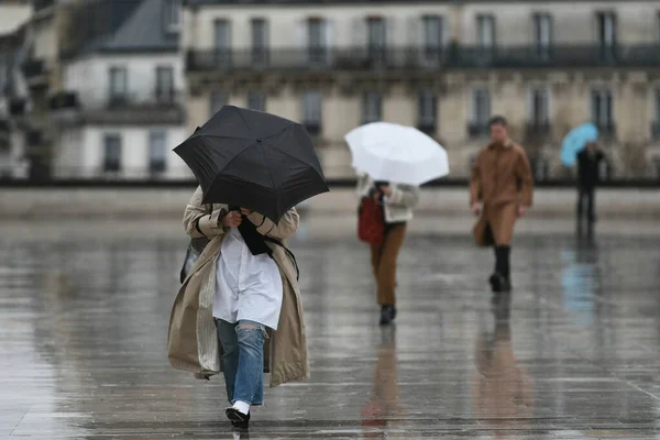 People with an umbrella in a rainy day in Paris