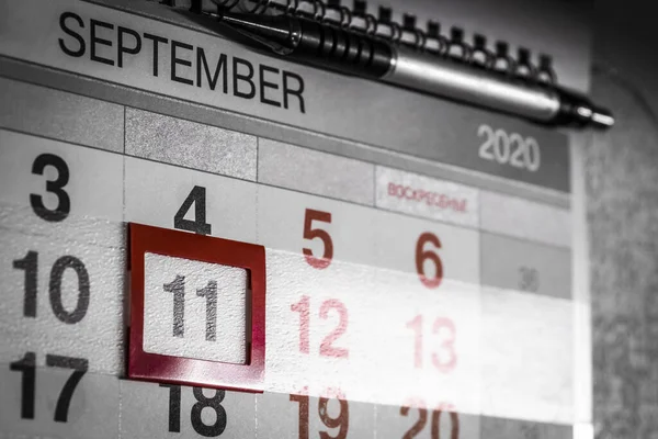 The date September 11 is highlighted on the wall calendar.