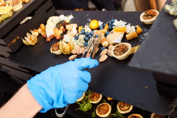 Snacks of tartlets with different fillings and nuts — Stock Photo, Image