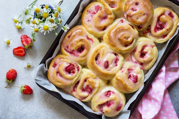 stock image Fresh Homemade Rolls Buns with strawberry with Cream Cheese in glaze for Breakfast  on a stone or slate gray background.Top view flat lay background.