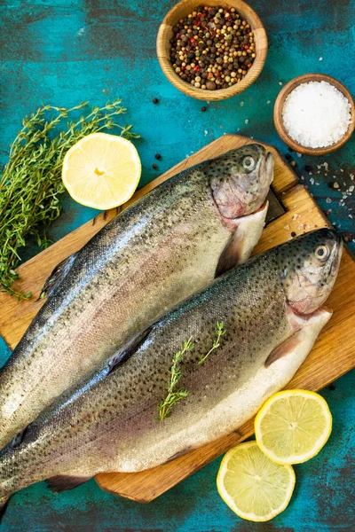 Fresh Fish. Raw Salmon, Lemon and Spice on a blue slate table.Copy space