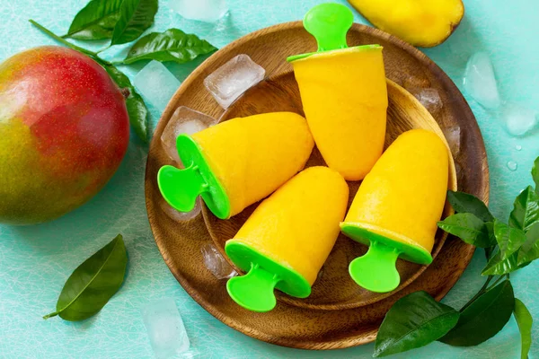 Healthy vegan orange mango citrus ice cream popsicle. Summer dessert. Top view flat lay background