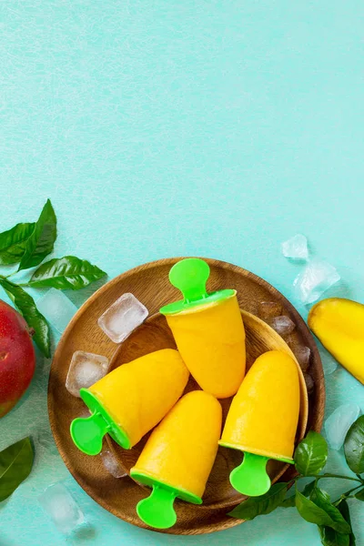 Healthy vegan orange mango citrus ice cream popsicle. Summer dessert. Top view flat lay background. Copy space.