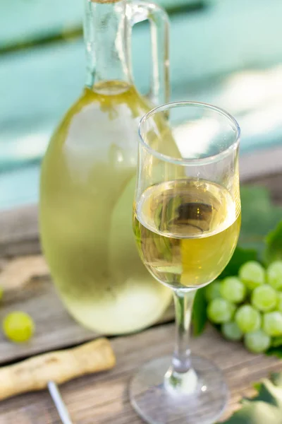 Wine background, wine concept. White wine bottles on wooden tabl