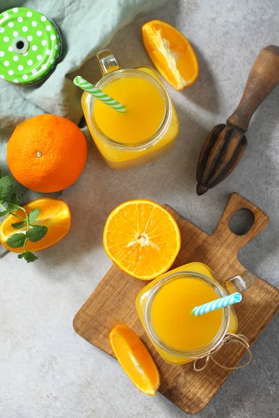 Refreshing juice made of orange, cold drink on a stone or slate — Stock Photo, Image