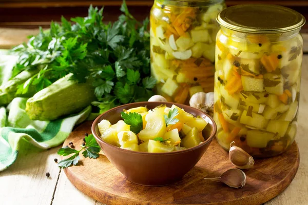 Homemade preserving. Pickled Zucchini Salad with vegetables on t