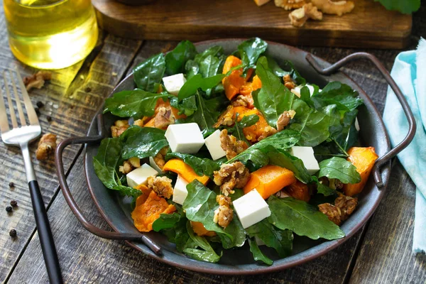 Diet menu, Vegan food. Healthy salad with baked pumpkin, feta, c