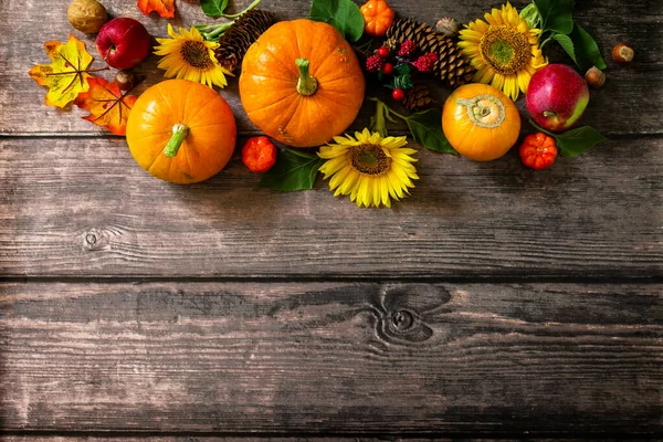 Happy Thanksgiving Background. Pumpkins, sunflowers, apples and fallen leaves. Top view flat lay. Copy space.