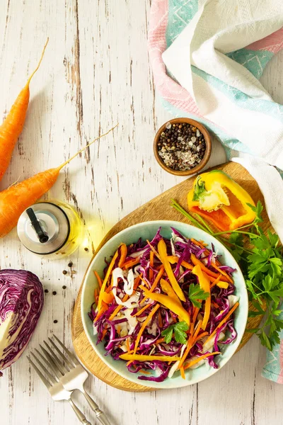 Cole Slaw. Cabbage salad in a bowl on a wooden table. Top view flat lay background. Copy space