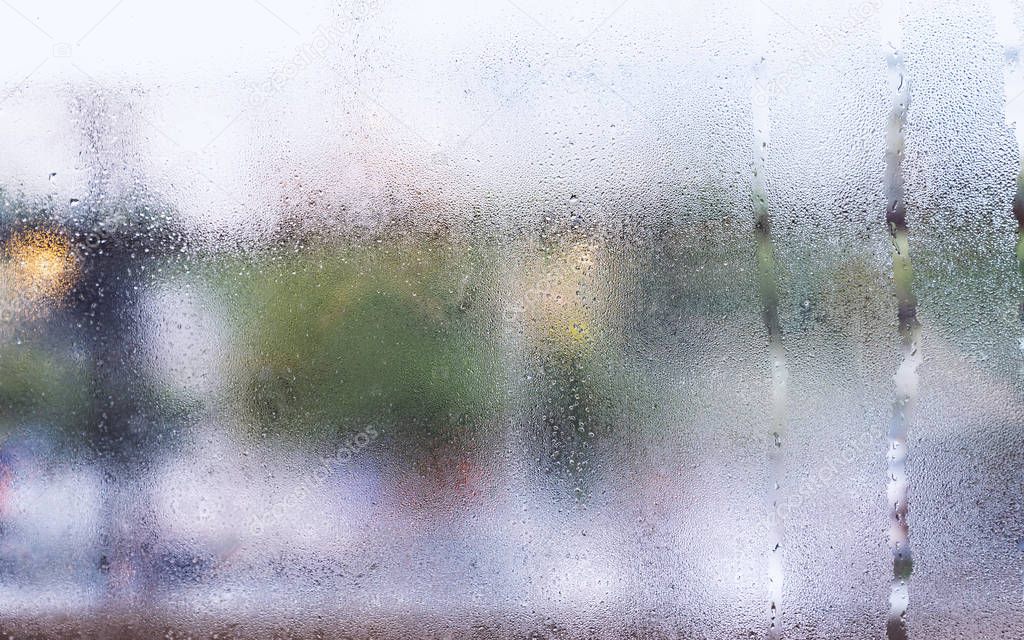 Water droplets condensation or steam background on glass after rainning in rainy day