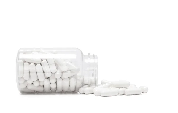 Капсулы Белого Лекарства Вытекают Прозрачной Бутылки Изолированы Белом Фоне — стоковое фото