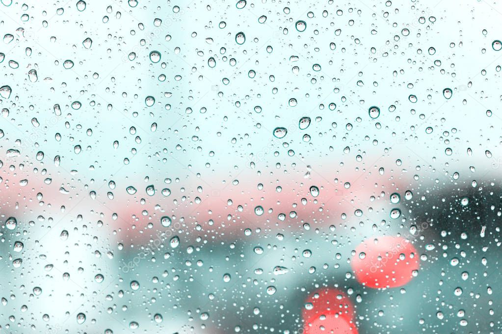 rain drops on car windshield after rain, water droplets on glass window in rainy season