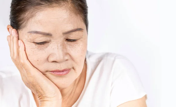 Old wrinkled asian woman thinking with copy space — Stock Photo, Image