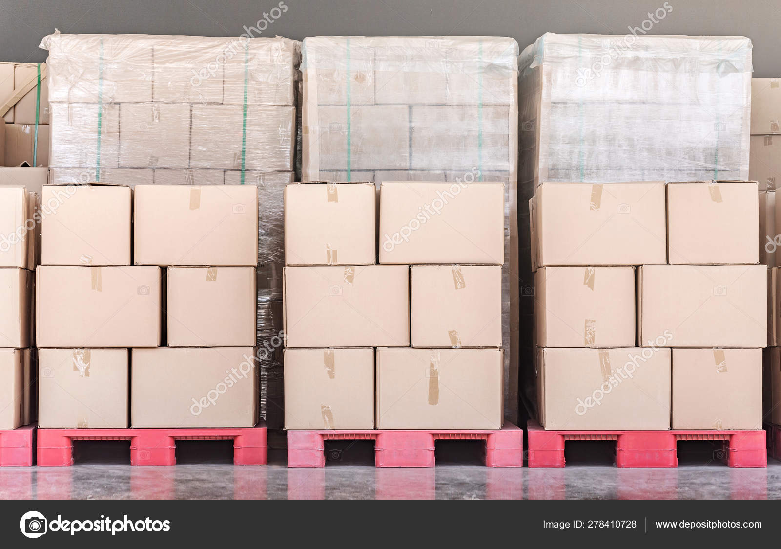 Stack of goods carton boxes on red pallet at logistics warehouse Stock