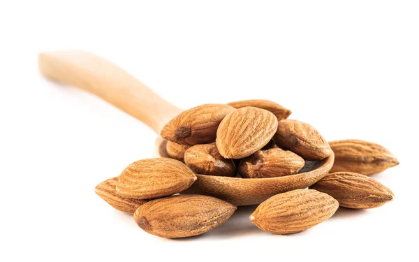 Almond seeds in wooden spoon isolated on white background — Stock Photo, Image