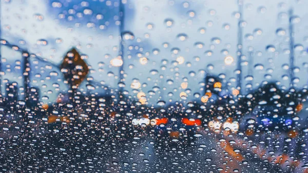風の盾に雨の季節に雨の降る渋滞の大都市道路で車を運転し — ストック写真