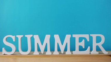 Yaz harf alfabe alan mavi ve ahşap arka plan üzerinde