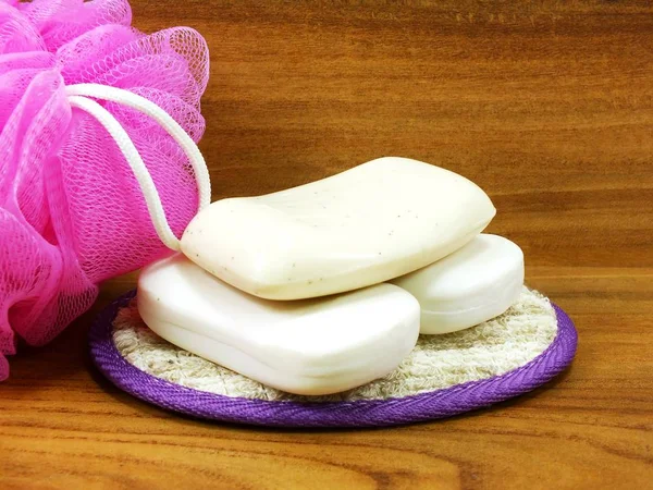 White Soap Plastic Bath Puff Wooden Background — Stock Photo, Image