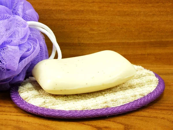 White Soap Plastic Bath Puff Wooden Background — Stock Photo, Image