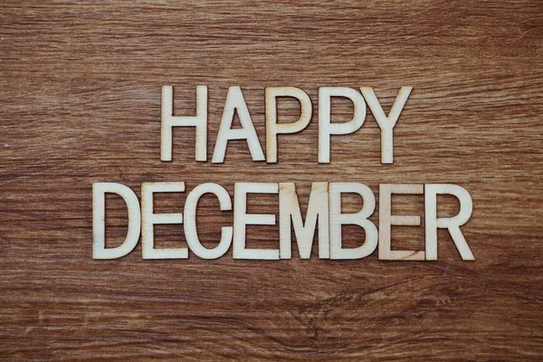 Happy December alphabet letters with space copy on wooden background