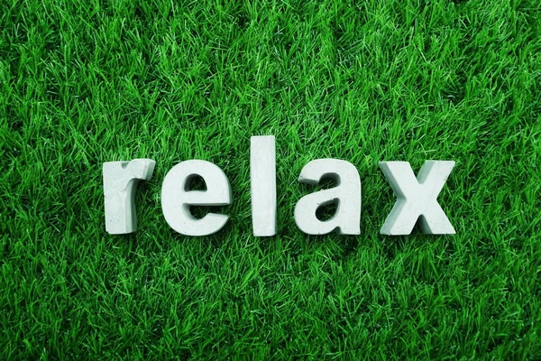 Relax alphabet letters on green grass background