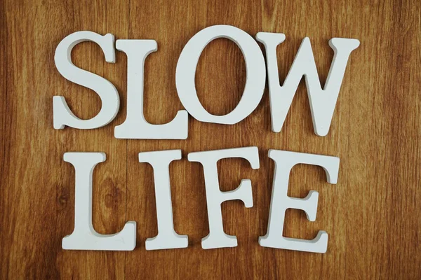 Slow life alphabet letter with space copy on wooden background