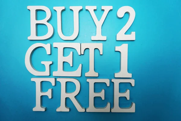 Buy two get one Free Sale Promotion on blue background