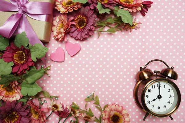 Vintage Alarm Clock and Pink Heart with space copy on pink polka dot background