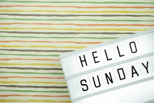 Hello Sunday word on light box with space copy on colorful background