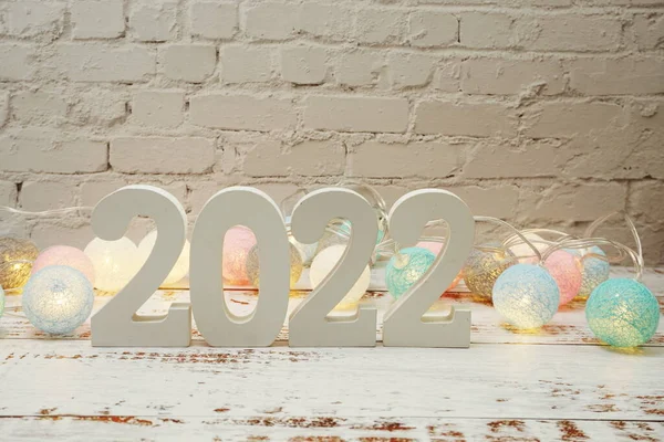 Happy New Year 2022 festive background with space on wooden background