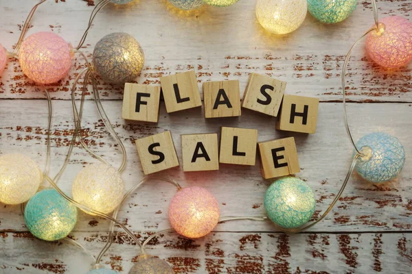 Flash Sale alphabet letter and LED cotton balls on wooden background