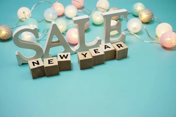 New Year Sale with led cotton balls decoration on pink background