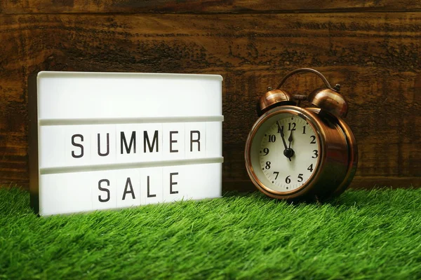 Summer Sale Text Light Box Alarm Clock Wooden Background — Stock Photo, Image