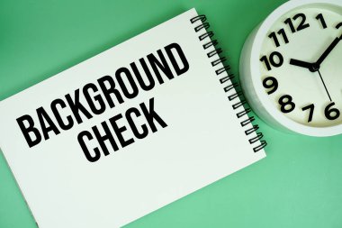 Background Check text with alarm clock flat lay on green background