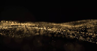 Altın parıltı ve ışıldayan ışık parçacıkları dalgalanıyor, ışıldayan toz bulutları sıçrıyor. Altın bokeh ışığı parlıyor, parıldayan kıvılcımlar siyah arkaplan üzerinde akıyor