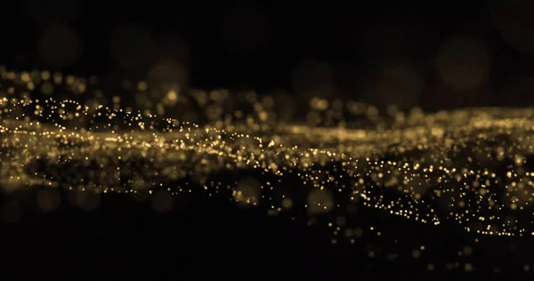 Gouden glitter golf, glinsterende deeltjes stromen spatten. Gouden bokeh licht gloeien, glinsterende vonken overlay op zwarte achtergrond — Stockfoto