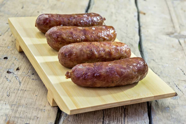 Cutting Board Four Grilled Sausages Rustic Table — Stock Photo, Image