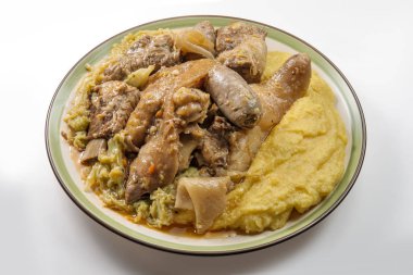 Plate with pork meat and savoy cabbage and polenta clipart