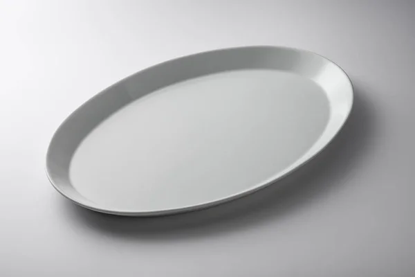 Isolated empty white oval plate — Stock Photo, Image