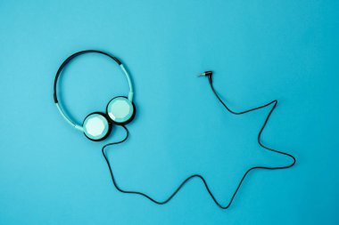 Tablo üstten görünüm radyo müzik arka plan kavramı dinleme aksesuarları hava görüntüsü. Rustik mavi kağıt modern duvar kağıdı düz yatıyordu kulaklıktan. Yaratıcı tasarım metin ve içerik için boş alan.