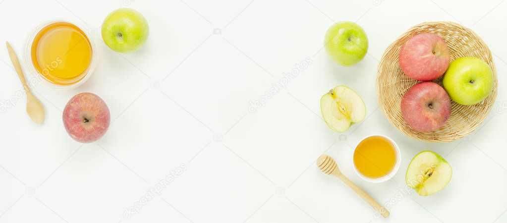 Table top view aerial image of decorations Jewish holiday Rosh Hashana background concept.Flat lay of variety apple & honey bee with wood basket on modern rustic white wooden.Free space for creative.