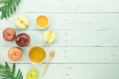 Masa üstü Rosh Hashana arka plan kavramı süslemeleri Yahudi tatil hava görüntüsünü görüntüleyin. Çeşitli elma ve bal arı modern rustik pastel yeşil ahşap düz yatıyordu. Sahte için yer açmak.