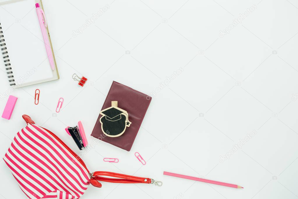 Table top view aerial image of back to school of education season background concept.Flat lay variety stationary with hand bag and essential objects on modern white wooden.Copy space for mock up.
