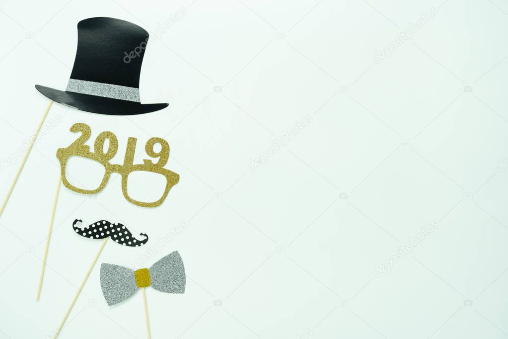 Table top view of Merry Christmas decorations & Happy new year 2019 ornaments concept.Flat lay essential difference objects to party season the photo booth prob on modern white wooden  background.