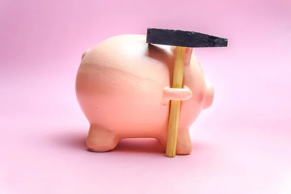 Piggy Bank con pequeño martillo aislado en rosa —  Fotos de Stock