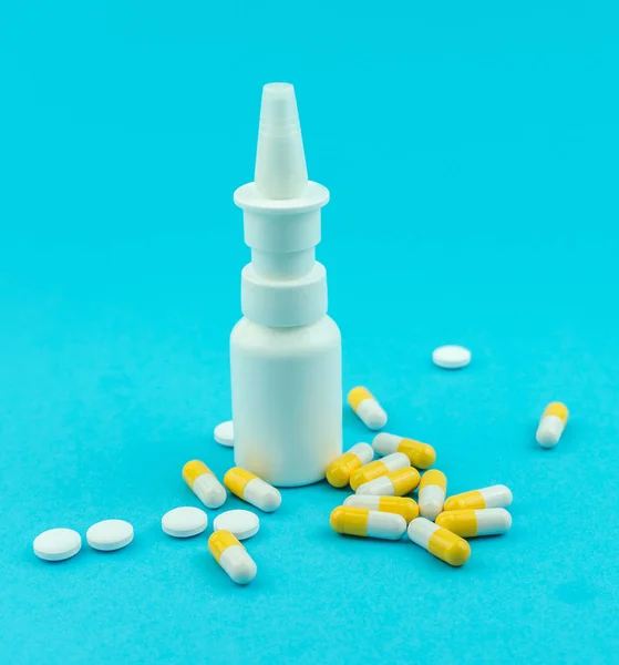 Pills, nasal spray isolated on blue background — Stock Photo, Image