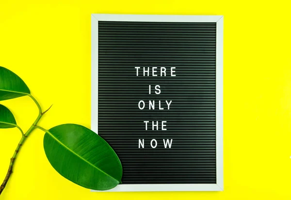 Mindfulness - do it NOW. There is only the NOW written on Letter board on yellow background