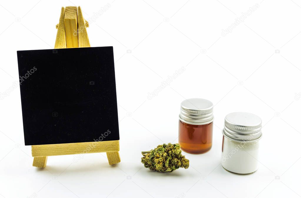Glass container with CBD Cannabidiol crystals, oil, flower bud and empty blackboard