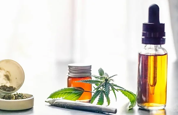 CBD Cannabidiol en THC-olie met gerold marihuana gewricht bloemknoppen en blad — Stockfoto
