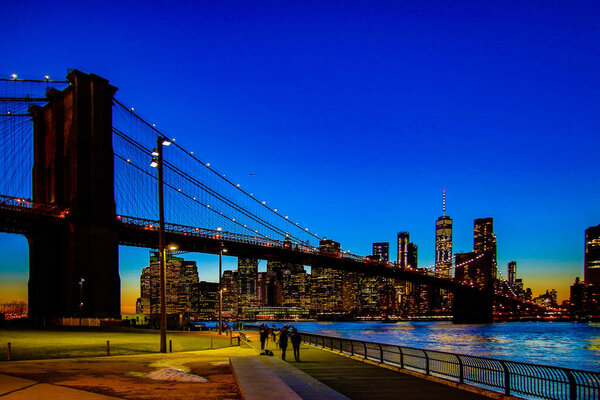 BROOKLYN, NEW YORK, MAR 27, 2018: Brooklyn Bridge, seen from Dumbo Park after sunset, during the 